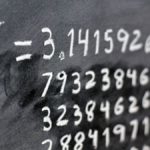 The number pi written out on a blackboard