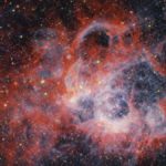 A giant cloud of red gas with stars inside