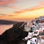 View over Santorini at sunset with the caldera in the background.