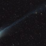 A green-tinged comet as seen in the night sky