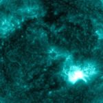 A bright flash on the sun showing where a solar flare erupted