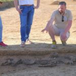 Archaeologist Florian Eibl beside the skeleton of