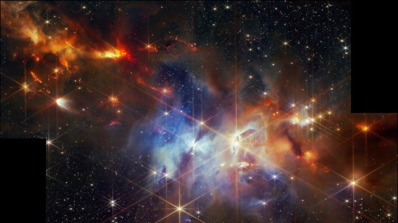 Потрясающее и красочное изображение звездообразующего газового облака, полученное телескопом, на котором видны красные полосы звездных вспышек новорожденных звезд.